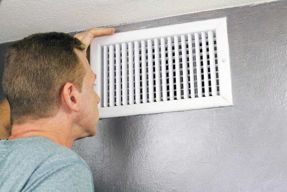 Image for Man looking in air vent